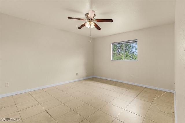 spare room featuring baseboards and a ceiling fan