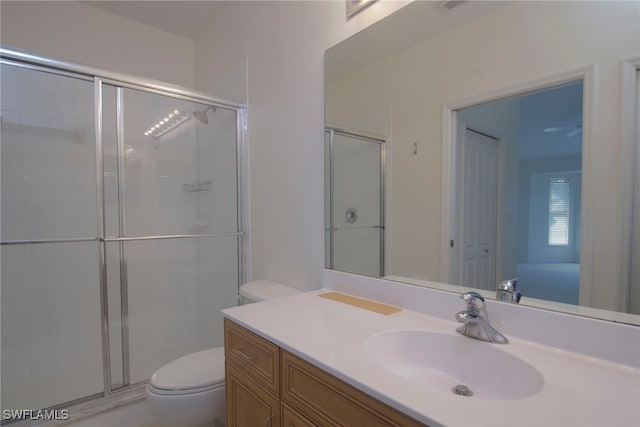 full bath featuring a closet, a shower stall, toilet, and vanity