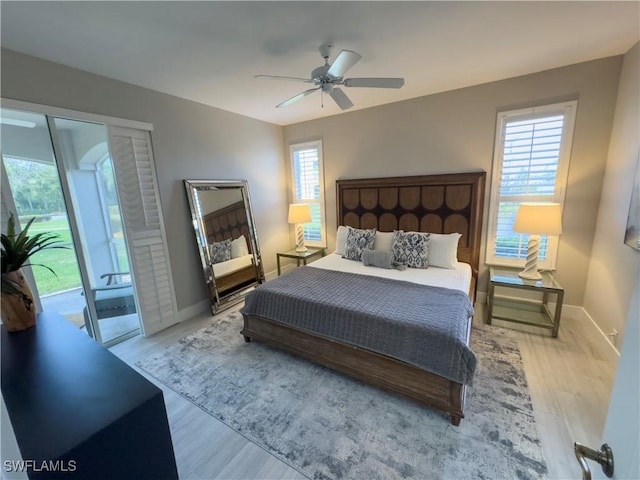 bedroom featuring access to outside, wood finished floors, and baseboards