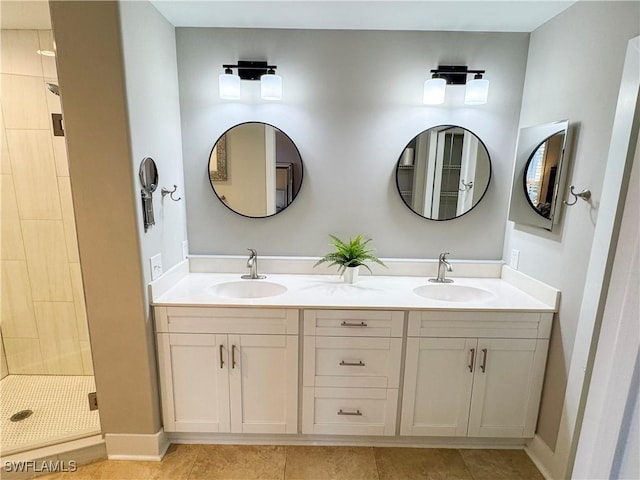 bathroom with a stall shower, tile patterned flooring, a sink, and double vanity