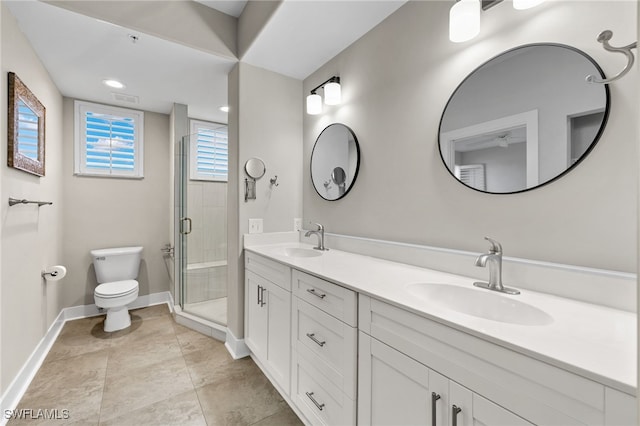 full bathroom with baseboards, a sink, a shower stall, and toilet