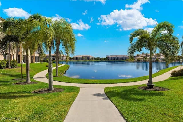 view of property's community with a water view and a yard