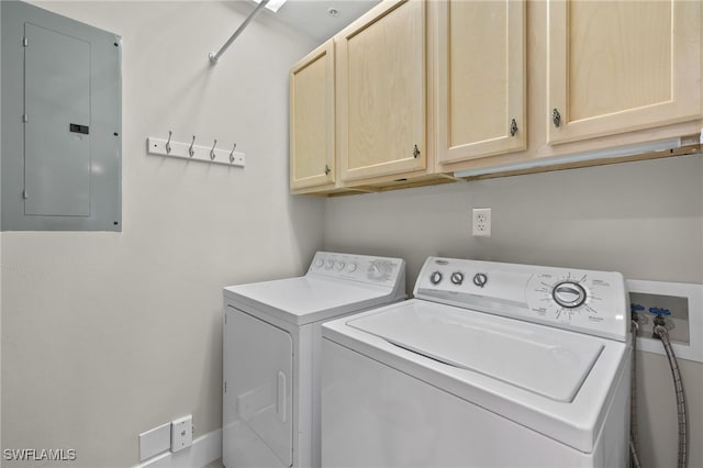 clothes washing area featuring cabinet space, electric panel, and washing machine and clothes dryer