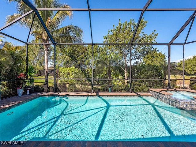 view of pool featuring an in ground hot tub and a lanai