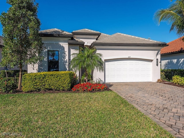 view of front of property with a garage and a front lawn