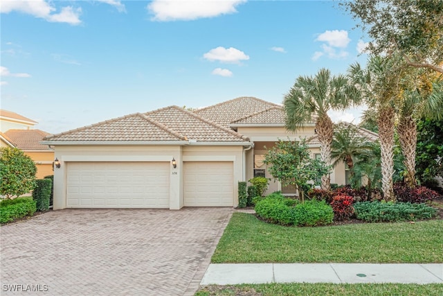 view of front of property with a garage and a front lawn