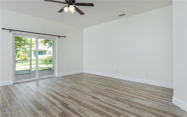 spare room with ceiling fan and light wood-type flooring