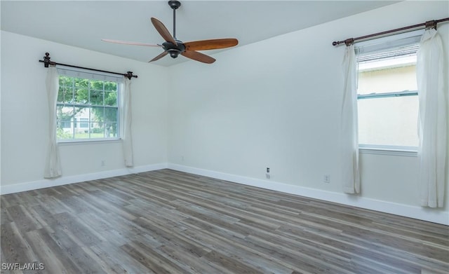 spare room featuring dark hardwood / wood-style floors and ceiling fan