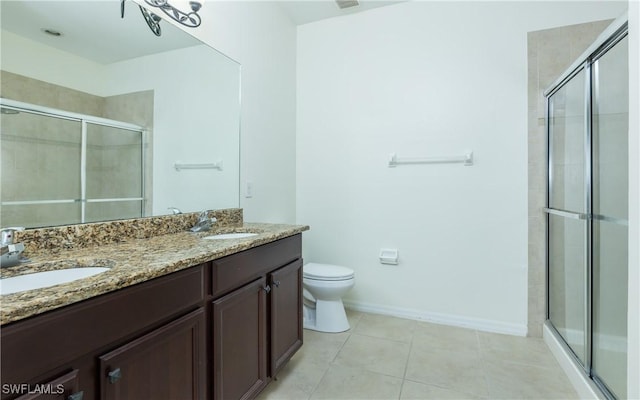 bathroom with walk in shower, vanity, toilet, and tile patterned flooring