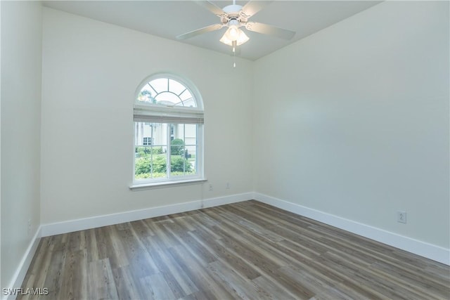 empty room with ceiling fan and hardwood / wood-style floors