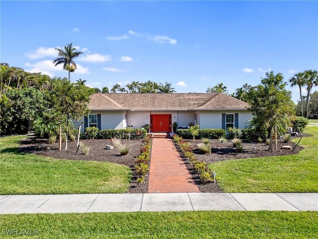 single story home featuring a front lawn