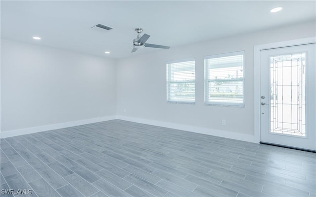 spare room featuring wood-type flooring and ceiling fan