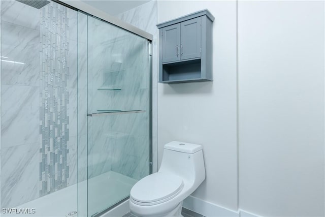 bathroom with an enclosed shower and toilet