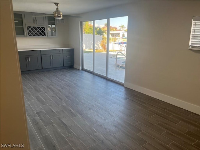 unfurnished dining area with dark hardwood / wood-style floors