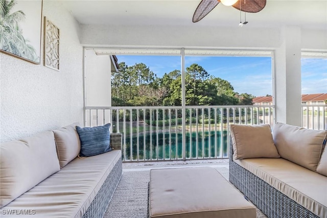 sunroom featuring ceiling fan