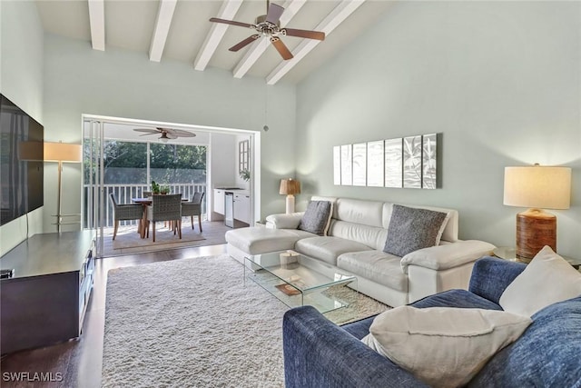 living area with beamed ceiling, high vaulted ceiling, ceiling fan, and wood finished floors