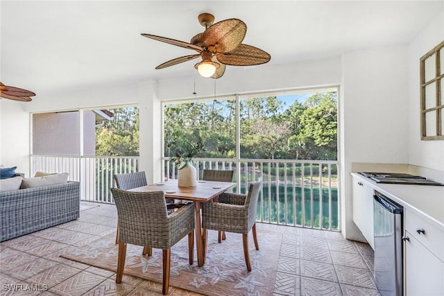 sunroom featuring a ceiling fan