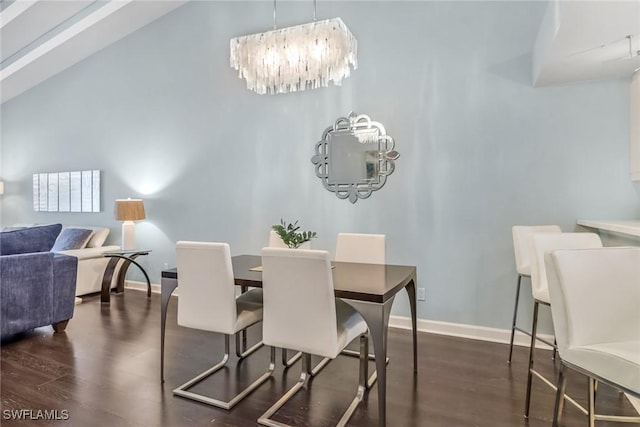 dining area with dark wood-style floors, baseboards, and a chandelier