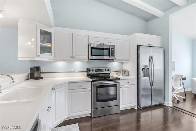 kitchen with appliances with stainless steel finishes, white cabinetry, and a sink