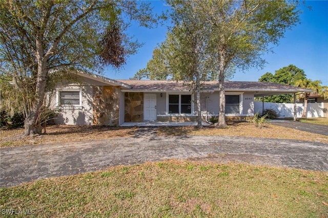 ranch-style house featuring a carport