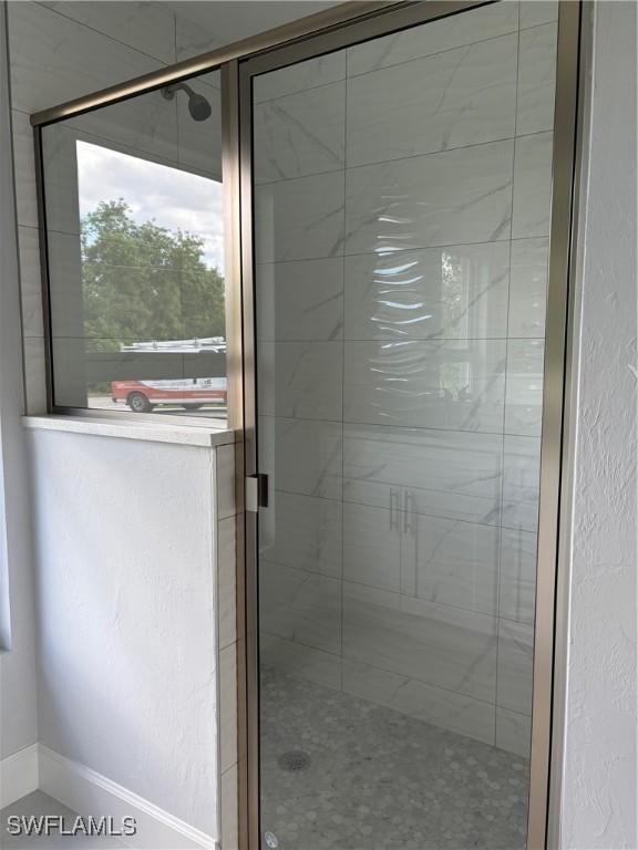 bathroom featuring a shower with shower door