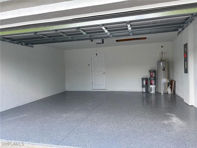 garage with a garage door opener and electric water heater