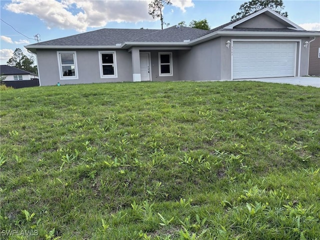 ranch-style home featuring a garage and a front lawn