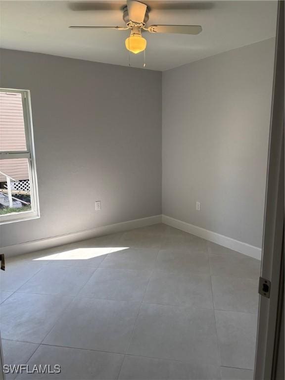 unfurnished room featuring light tile patterned floors and ceiling fan