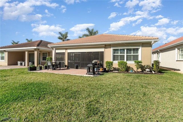 rear view of house featuring a yard and a patio area