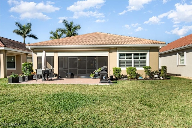 back of property featuring a yard and a patio