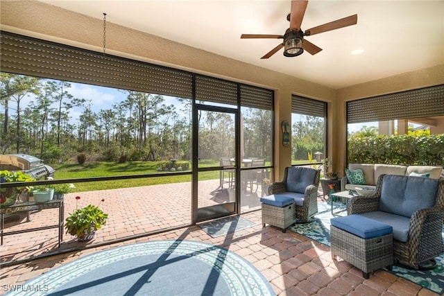 sunroom featuring ceiling fan and a healthy amount of sunlight