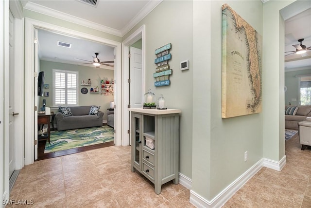 hallway featuring ornamental molding and light tile patterned floors