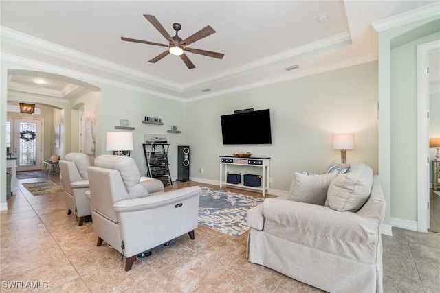 living room with french doors, crown molding, ceiling fan, and a tray ceiling