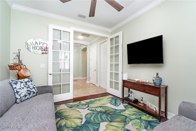 living room with wood-type flooring, ornamental molding, french doors, and ceiling fan