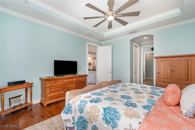 bedroom featuring a raised ceiling, crown molding, dark hardwood / wood-style floors, and ceiling fan