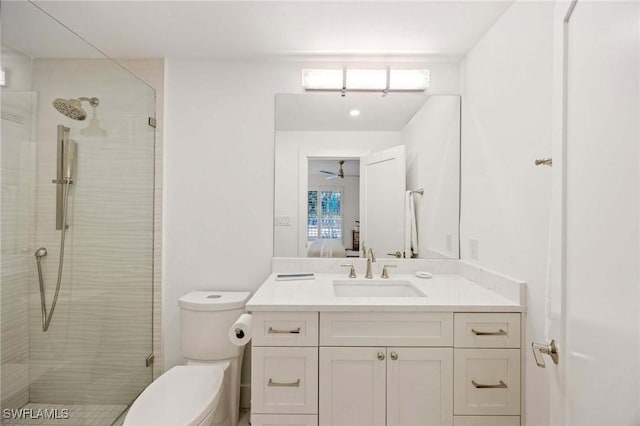 ensuite bathroom with toilet, a stall shower, connected bathroom, and vanity