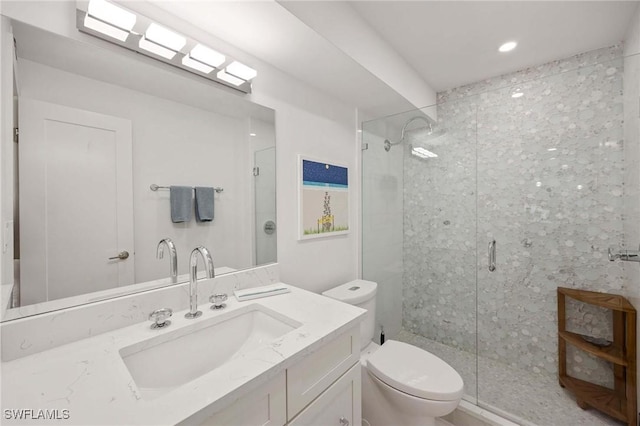 full bath with toilet, a shower stall, and vanity