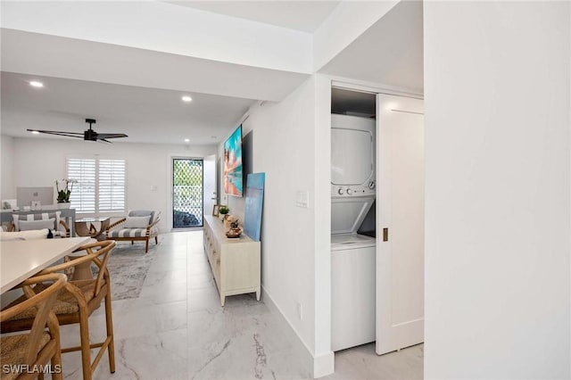 interior space featuring baseboards, a ceiling fan, stacked washer / drying machine, marble finish floor, and recessed lighting