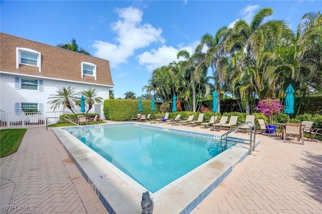 pool featuring a patio area and fence