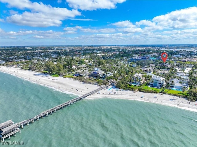 birds eye view of property with a water view and a view of the beach