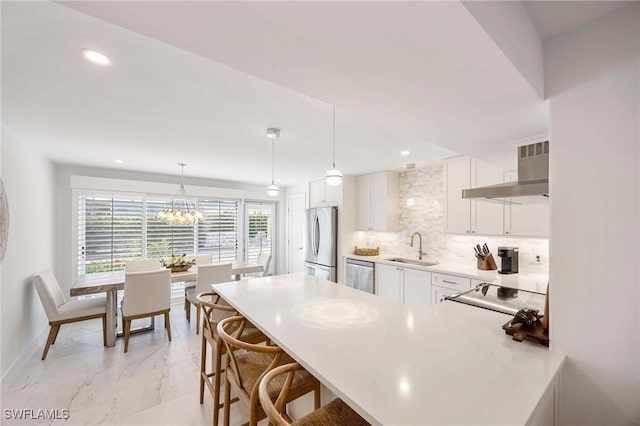 kitchen with range hood, marble finish floor, decorative backsplash, appliances with stainless steel finishes, and a sink