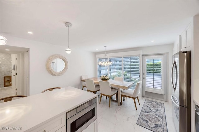 kitchen with marble finish floor, stainless steel appliances, white cabinetry, and recessed lighting