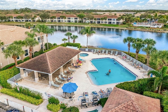 community pool featuring a water view, fence, a gazebo, a residential view, and a patio area