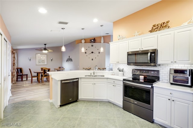 kitchen featuring white cabinetry, appliances with stainless steel finishes, light countertops, and a sink