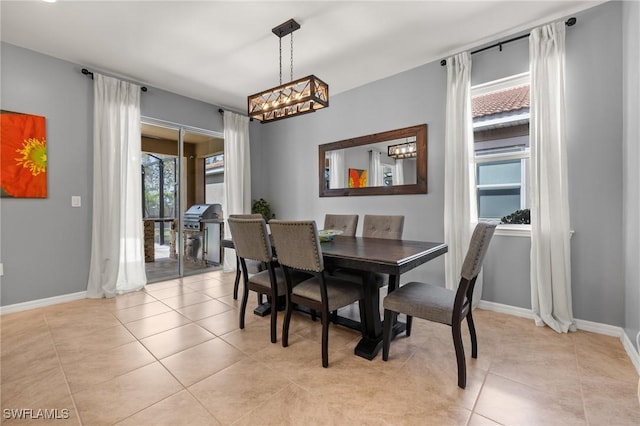 dining area with light tile patterned flooring and baseboards