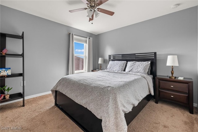 bedroom featuring light carpet, ceiling fan, and baseboards