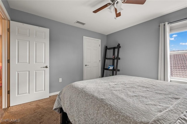 carpeted bedroom with visible vents, ceiling fan, and baseboards