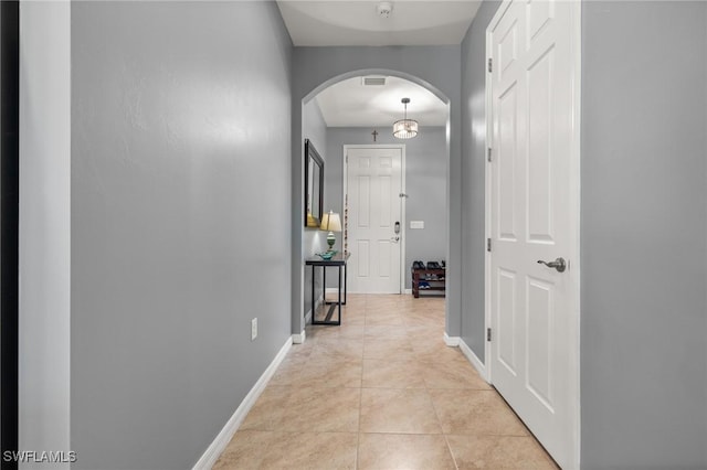 hall featuring light tile patterned floors