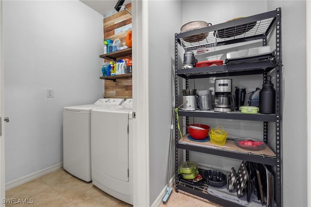 laundry area with washing machine and dryer, laundry area, and baseboards