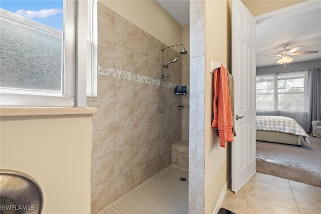 ensuite bathroom featuring a walk in shower, ensuite bath, a ceiling fan, and tile patterned floors